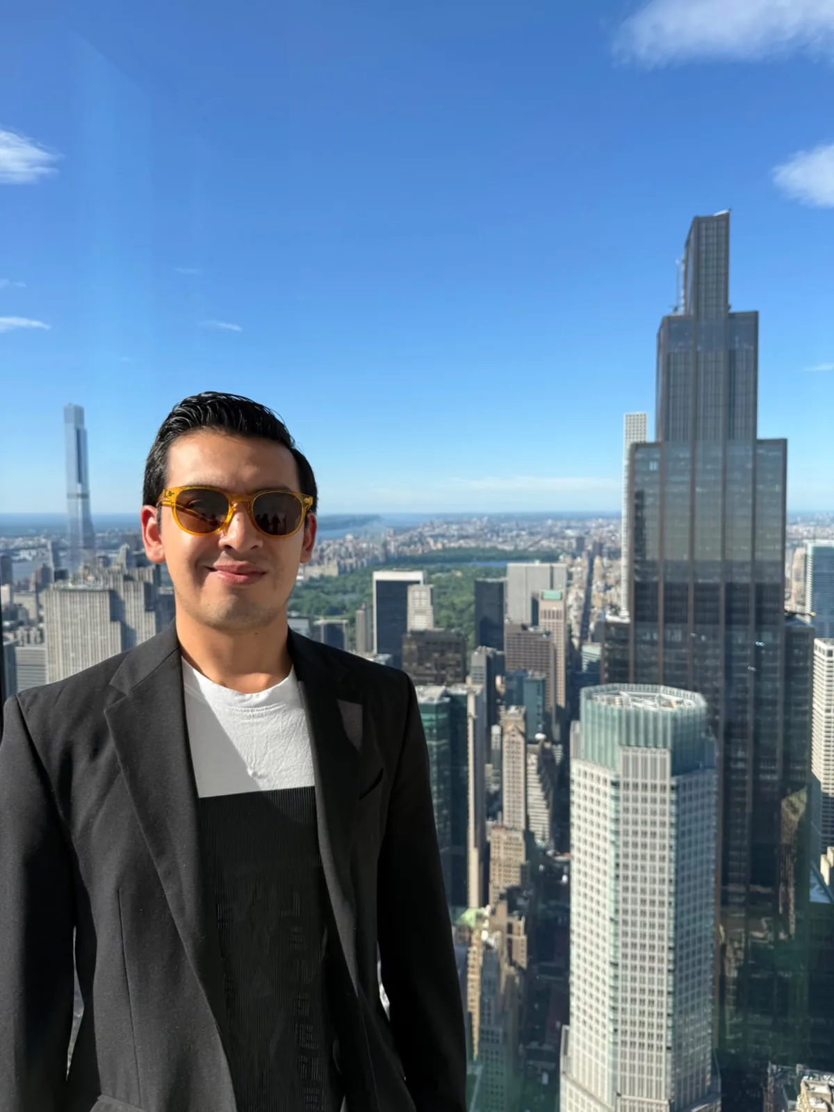 Portrait of Israel Teran with a city skyline in the background